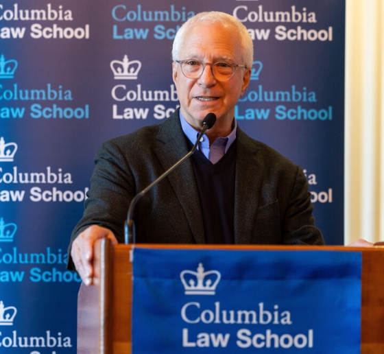 Jim Millstein in glasses behind a Columbia Law School podium