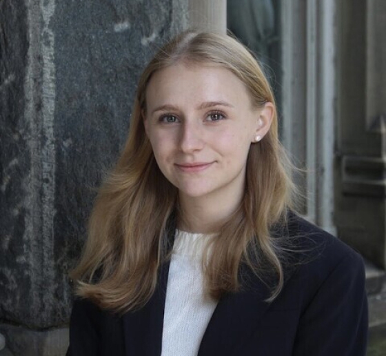 Young woman with long blonde hair in white shirt and black jacket