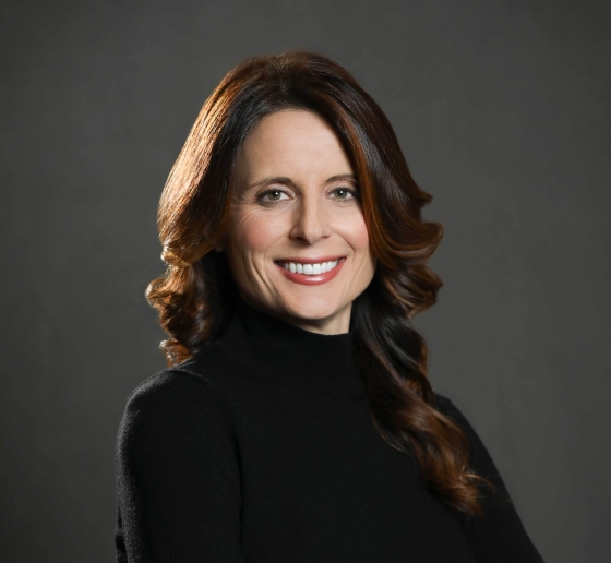 Olena Ripnick-O'Farrell who has long auburn hair and is wearing a dark sweater
