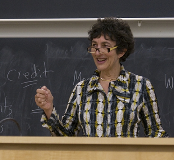 Carol Sanger teaches from a lectern in front of a blackboard.