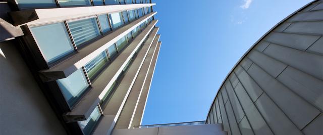 Looking up at the facade of Jerome Greene Hall.