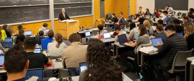 Students sit in a lecture hall.