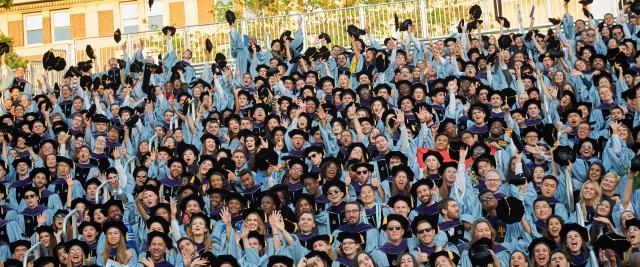 Students tossing their mortarboards at Graduation