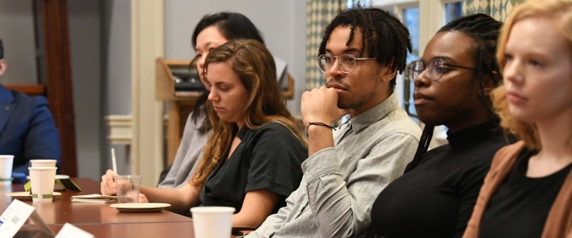 PI/PS Fellows sit a long table at event featuring guest James Comey.