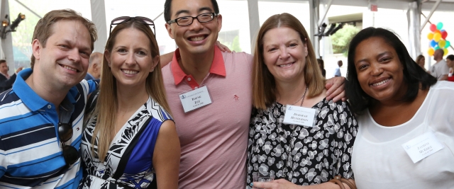 Five alumni smile in the tent at the family luncheon at Reunion 2016