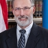 J. Travis Laster
