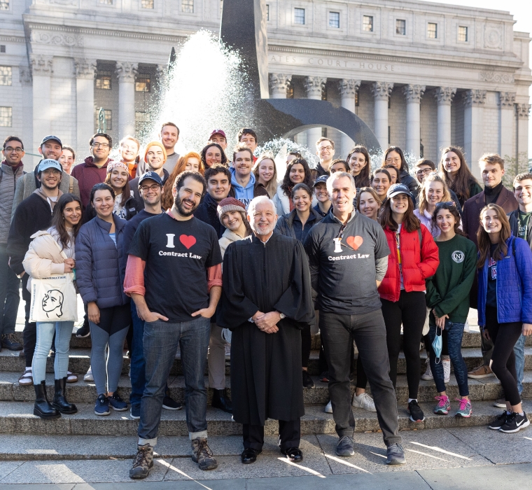 Students in the Contracts classes of Professor Eric Talley and Visiting Professor Julian Arato pose for a photo with Judge Jed Rakoff in front of the Thurgood Marshall United States Courthouse.