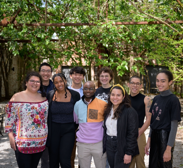 Group of nine law students standing in a shady courtyard