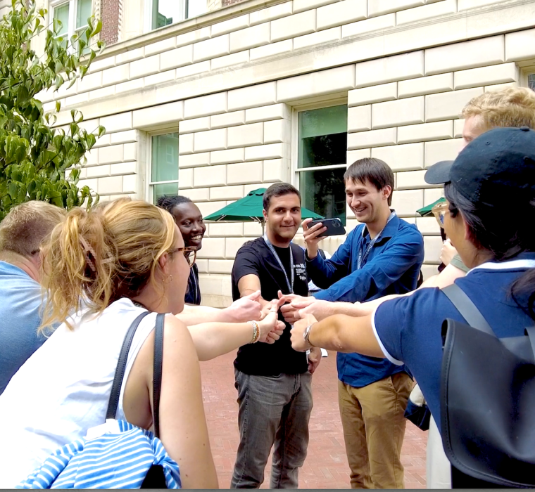 Students touch hands together during Orientation 2023