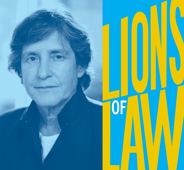 Woman with short hair and dark jacket next to Lions of Law graphic logo