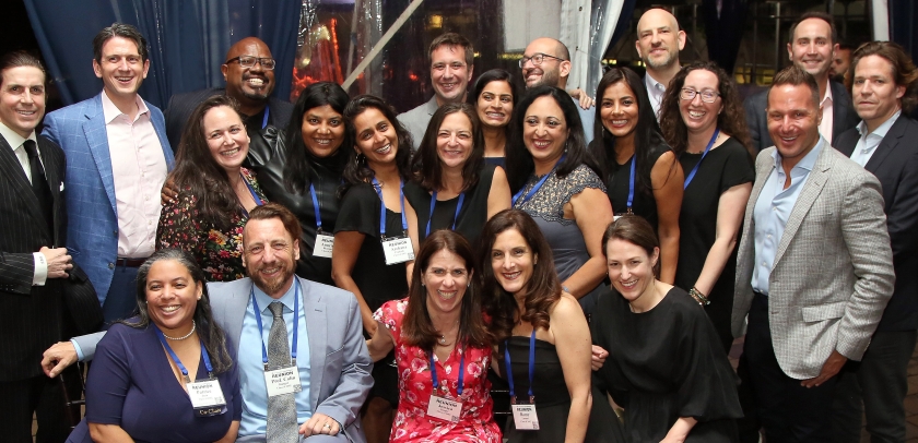 A group of about 20 people posing together