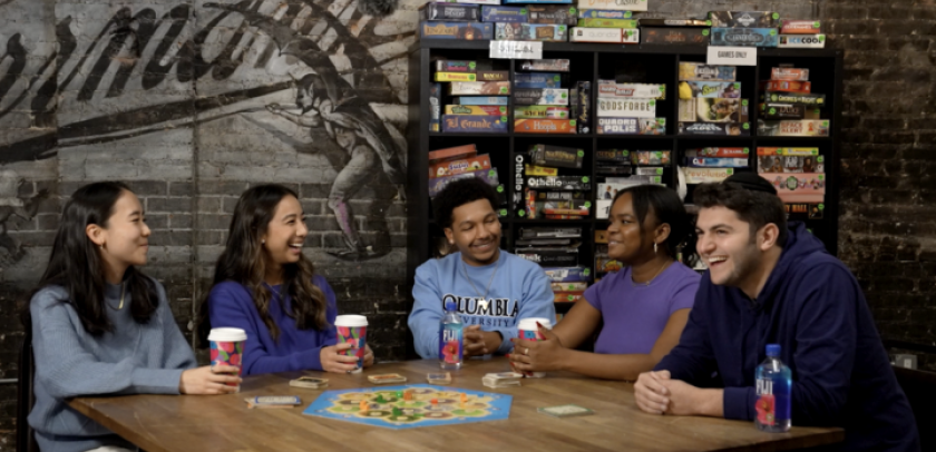 Young people gathered around a table, with coffee