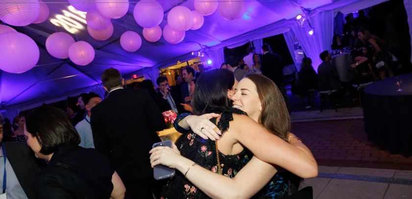 Women hugging in party tent