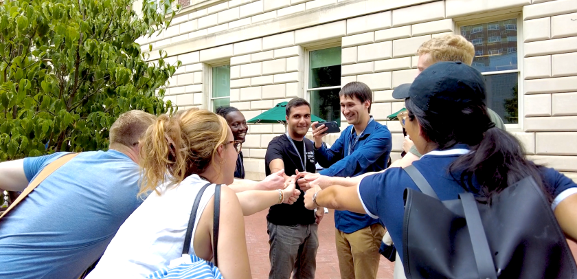 Students touch hands together during Orientation 2023