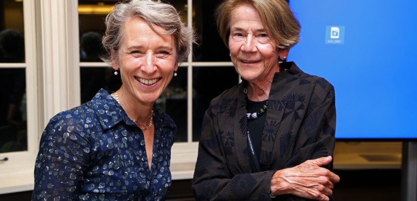 Blonde woman and brown haired woman smiling 