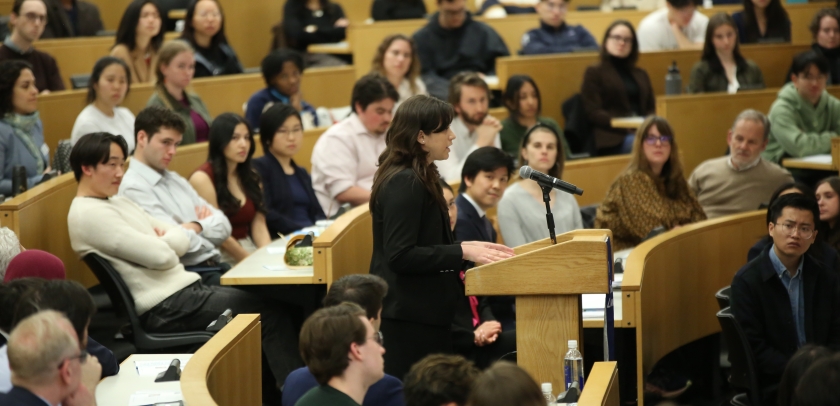 A speaker at a podium in a classroom