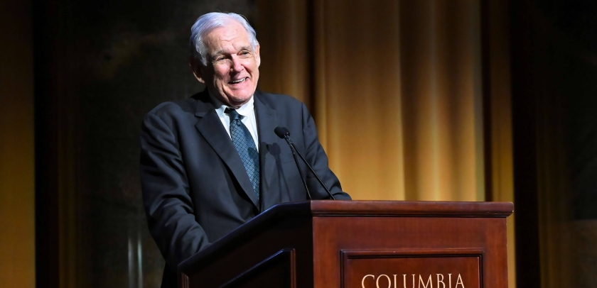 Professor George Bermann in suit and tie speaking in front of a Columbia University podium