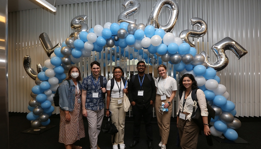Six members of the class of 2025 pose in front of blue and white balloon arch with additional silver balloons that spell out CLS 2025.