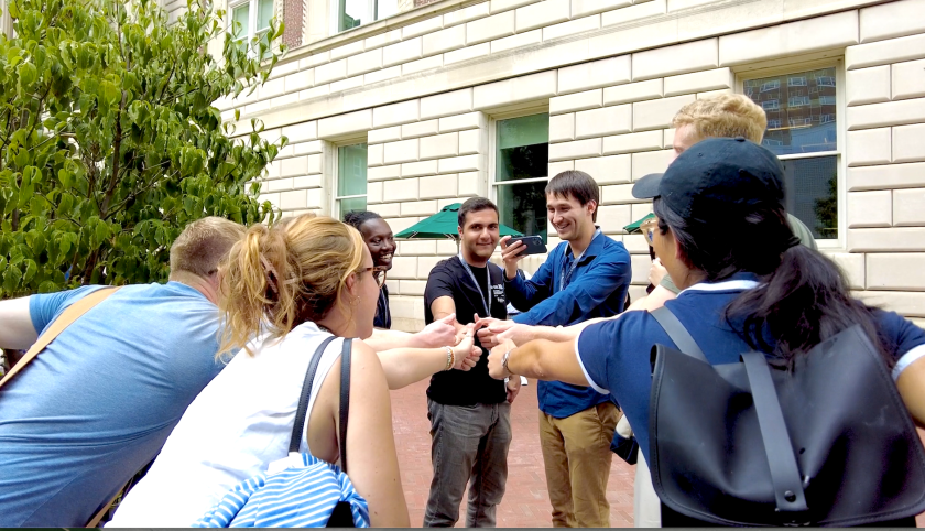 Students touch hands together during Orientation 2023
