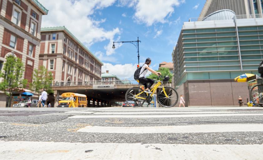 Student biking on Amsterdam and 116th Street