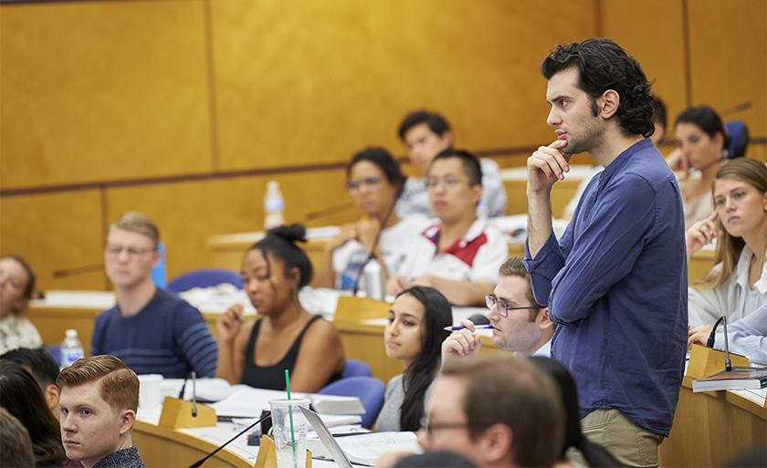 Student standing in a lecture hall during class