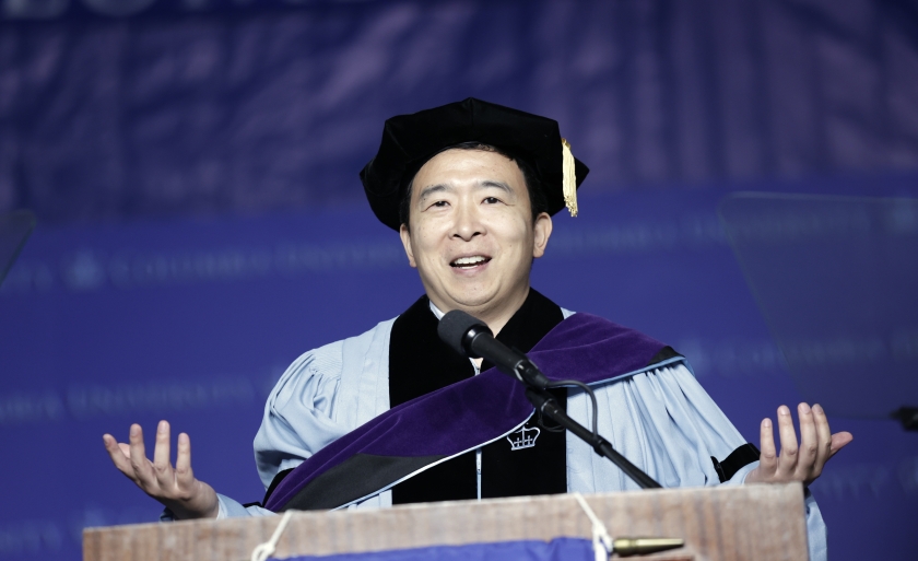 Man in cap and gown at podium