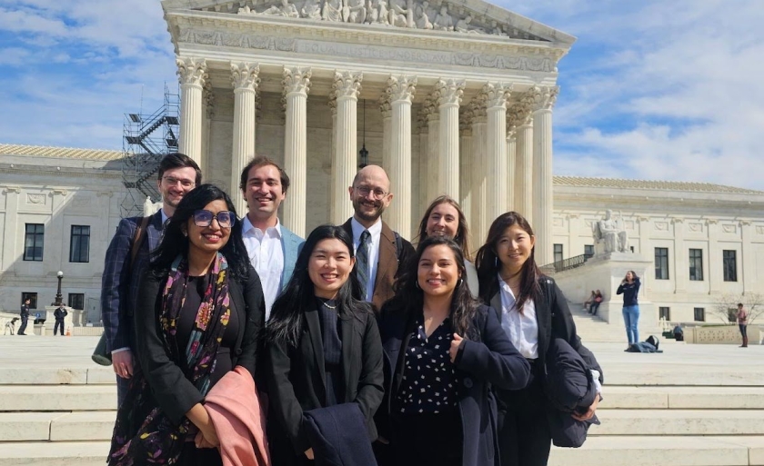 Students in the Science, Health, and Information Clinic pose with Christopher Morten in front of the Supreme Court.