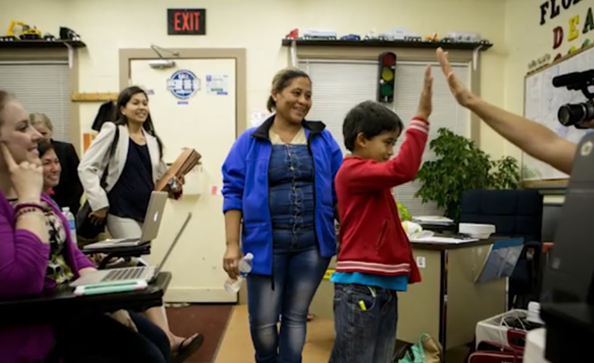 Photo from the New York Times depicting the release of a child and their mother from detention.