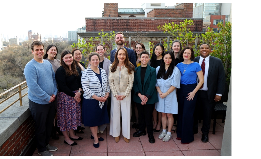 The PIPS office staff poses for a group photograph on a rooftop terrace.