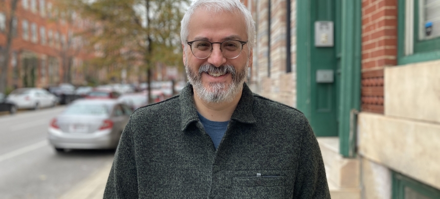 Simon Canick in grey jacket on city street
