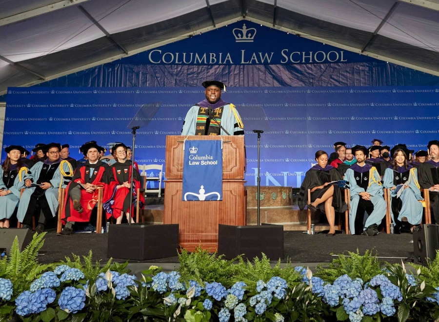 Stage of Columbia Law graduation with hydrangeas and dignitaries