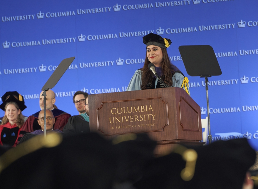 Woman in academic regalia at podium