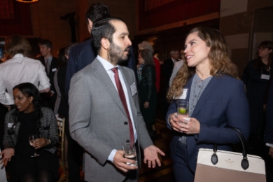 Man and woman alumni chatting