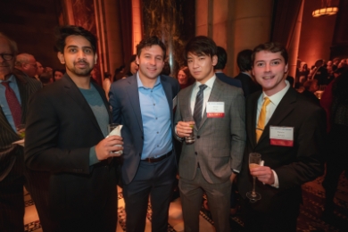 Four male law students in business attire