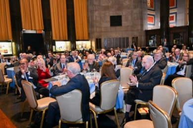 Audience seated at round tables in Low Library at Columbia University