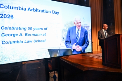 Dean Abebe speaking before an image of George Bermann