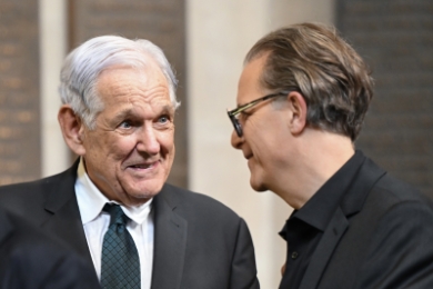 Professor George Bermann in tie and jacket talking to Bernard Harcourt in glasses