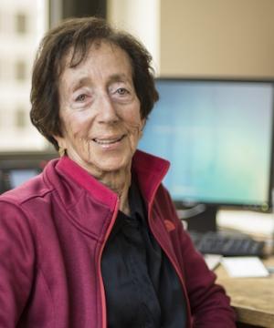 Woman in red jacket sitting at computer