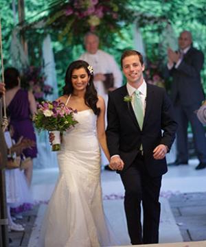 Nina and Travel walk down the aisle at their wedding.