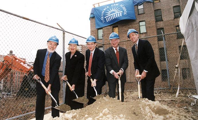 Gerry and Marguerite Lenfest pose with shovels and hardhats as they dig into a pile of dirt at the Lenfest Hall groundbreaking.