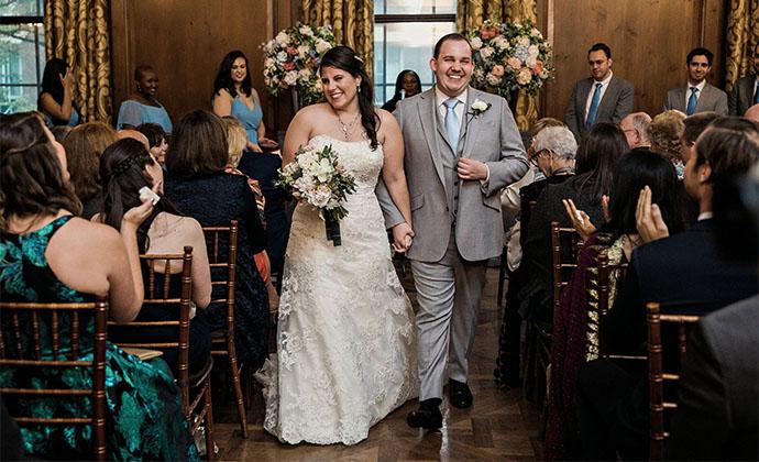 Fiona and Josh walk down the aisle at their wedding.