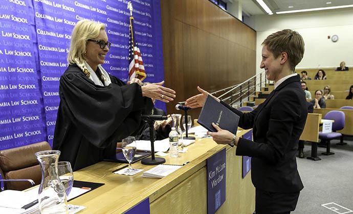 Judge Kim Wardlaw congratulates Emily Hush on winning best oral presentation.