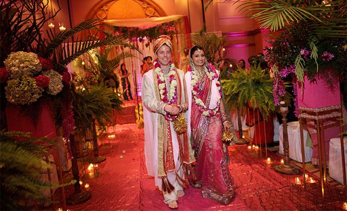 Nina and Travel walk down the aisle at their wedding.