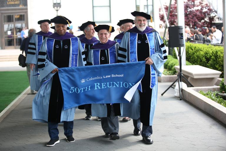 Alumni carry a banner