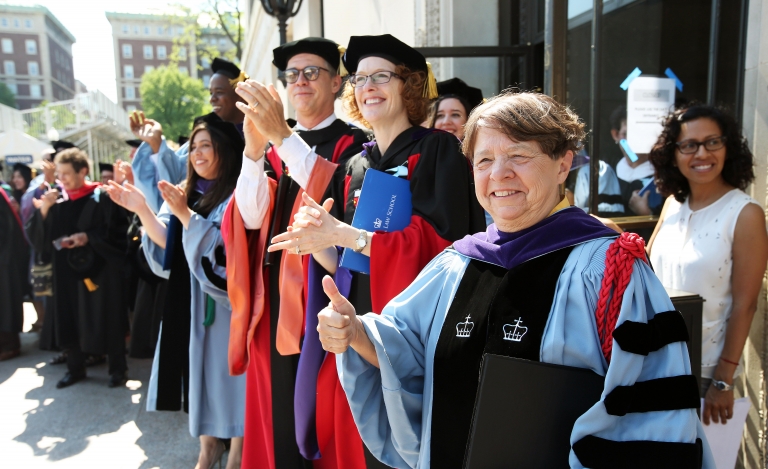 Keynote speaker Mary Jo White ’74, wearing blue academic robes, gives the thumbs up at Graduation 2017.