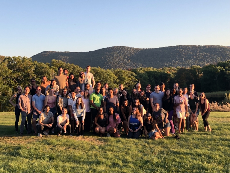 Group photo of the Columbia Law Review editorial staff in a green field in the Catskills