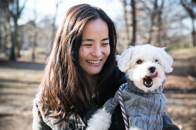 Sarah A. Seo holding her white Maltipoo dog