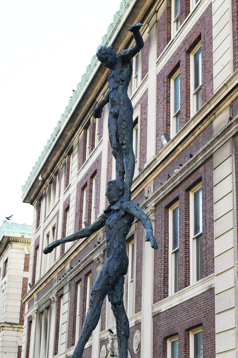 Tightrope Walker sculpture by Kees Verkade; a bronze statue of one figure standing on another's shoulders