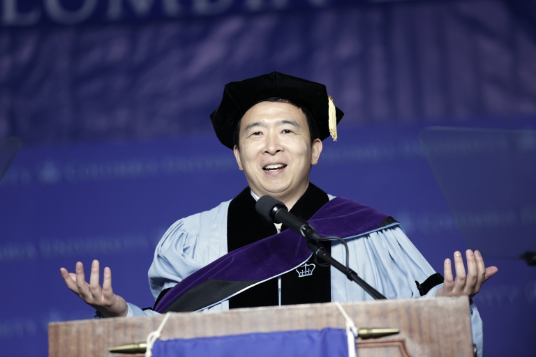 Man in cap and gown at podium