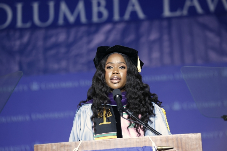 Woman in cap and gown at podium